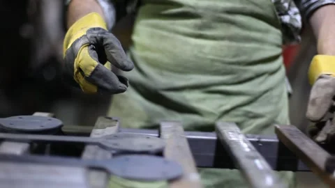 Close-up blacksmith welder in protective mask works with metal using a welding Stock Footage 139586999
