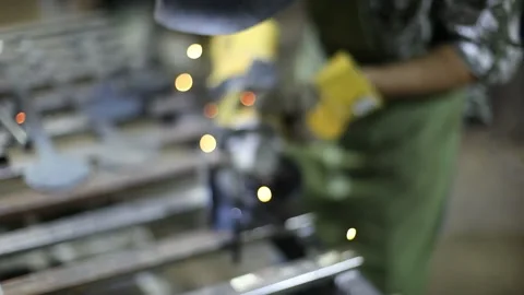 Close-up blacksmith welder in protective mask works with metal using a welding Stock Footage 139587138