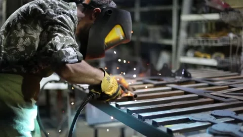 Close-up blacksmith welder in protective mask works with metal using a welding Stock Footage 139588717