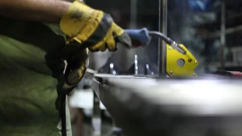 Close-up blacksmith welder in protective mask works with metal using a welding Stock Footage 139588768