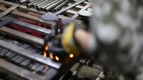 Close-up blacksmith welder in protective mask works with metal using a welding Stock Footage 139588831