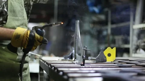 Close-up blacksmith welder in protective mask works with metal using a welding Stock Footage 139590080