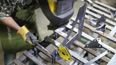 Close-up blacksmith welder in protective mask works with metal using a welding Stock Footage 139590318