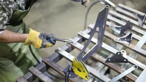 Close-up blacksmith welder in protective mask works with metal using a welding Stock Footage 139590474