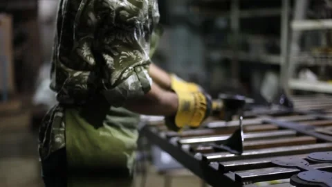 Close-up blacksmith welder in protective mask works with metal using a welding Stock Footage 139590800