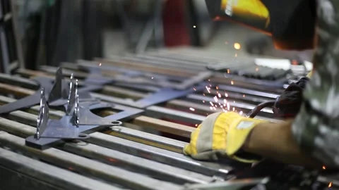 Close-up blacksmith welder in protective mask works with metal using a welding Stock Footage 139591340