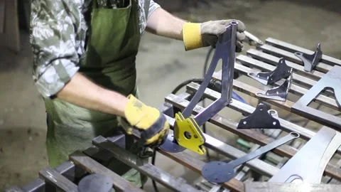 Close-up blacksmith welder in protective mask works with metal using a welding Stock Footage 139592087