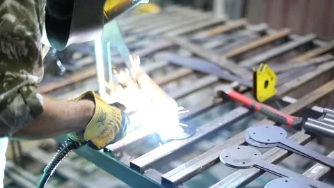 Close-up blacksmith welder in protective mask works with metal using a welding Stock Footage 139592388