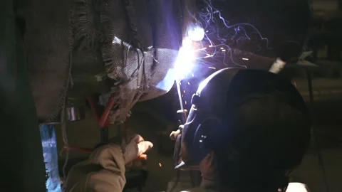 Close-up blacksmith welder in protective mask works Stock Footage 161342399