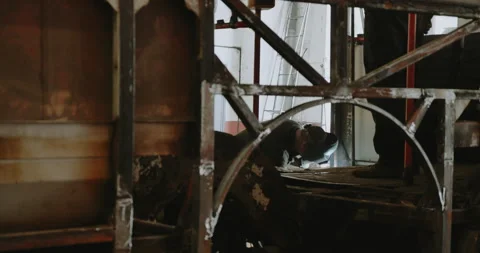 Close-up blacksmith welder in protective mask works with metal steel and iron Stock Footage 201619220