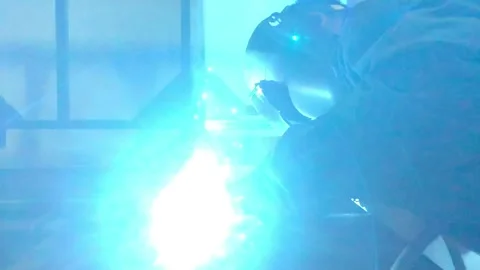 Close-up blacksmith welder works with  welding machine. Stock Footage 182729144