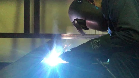 Close-up blacksmith welder works with  welding machine. Stock Footage 182729358