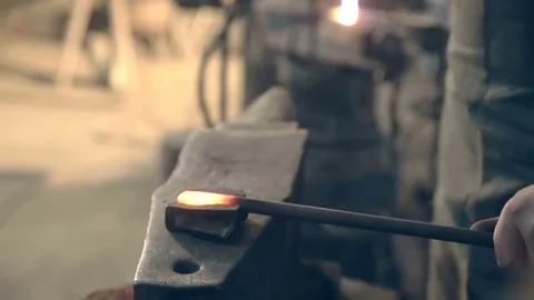 Close-up blacksmith who shapes hot steel with a hammer Stock Footage 77006051