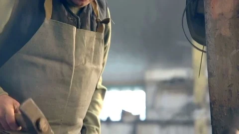 Close-up Blacksmith working Metal with hammer on the anvil in the forge Stock Footage 77026965