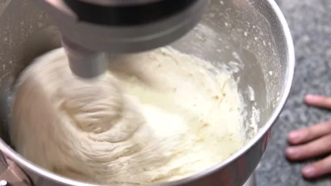 Close-up of the blade of a professional mixer preparing a bread dough with .. Stock Footage 282310525