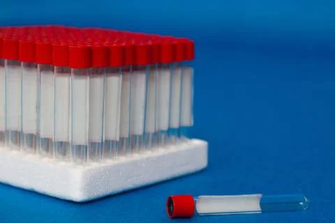 Close up blank laboratory test tubes with red caps ready for use Stock Photos