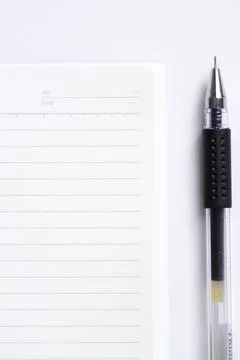 Close-up of blank notebook and pen isolated on white background Stock Photos