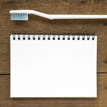 The close up of blank white notebook and the white toothbrush 스톡 사진
