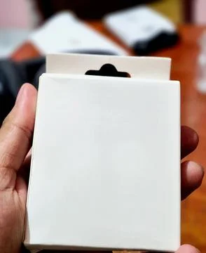 Close-up of a blank white product packaging box mockup held by hand Stock Photos