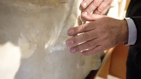 Close up of blind man's hands touching Parthenon marbles at the tactual muse Stock Footage 148376454