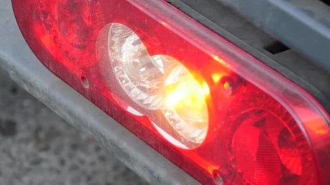 Close up of blinking amber turn signal lamp on truck tail light assembly in.. Stock-Footage 333033146