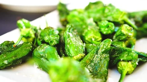 Close-up of Blistered Padrón Peppers (Pimientos de Padrón) at a tapas bar Stock Footage 282661064