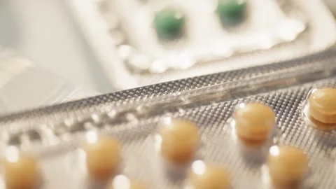 Close-up of blisters with pills lying on the table. Stock Footage 278831209