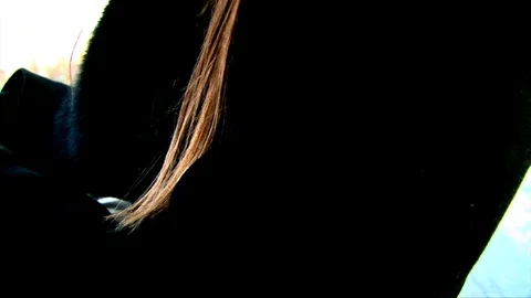 Close up blond hairs on black jacket on wind Video stock 72284149