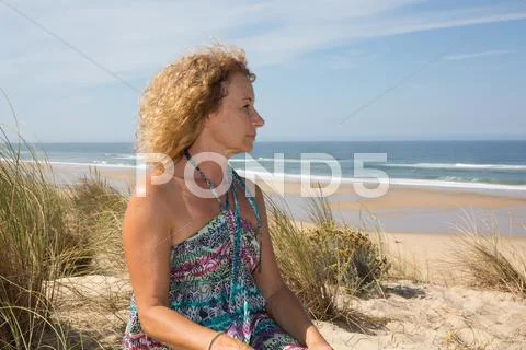 Close-up of blond woman wearing a dress thoughtful Stock Photos