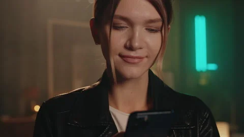 Close up blond young woman stand using smartphone typing feel happy in modern Stock Footage 252140651