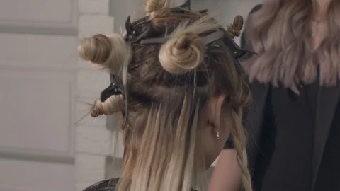 Close-up of blonde head with ponytails and pigtails spinning in a chair Stock Footage 101602002