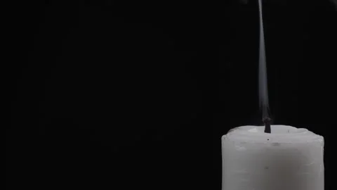 Close up blowing out candle in corner isolated black background Stock Footage 278958536