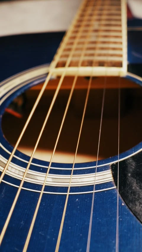 Close Up of Blue Acoustic Guitar Strings and Soundhole Stock Footage 325802628