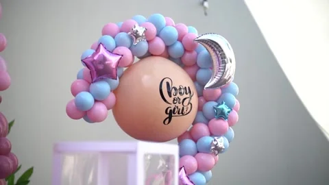 Close-up of Blue and Pink Balloon Garlands for Baby Gender Reveal Celebration Stock Footage 341008820