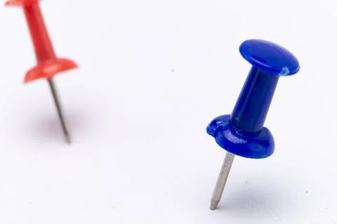 Close-up of a Blue and Red Push Pins on a White Background, Office Supplies. Stock Photos