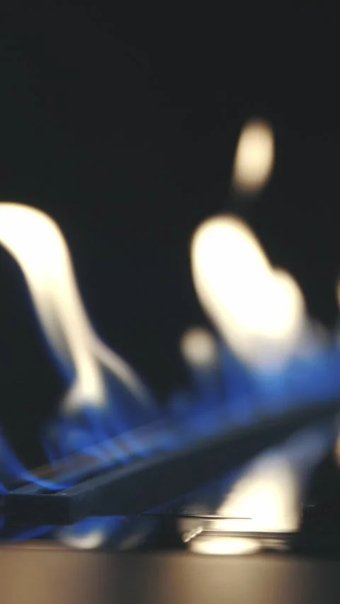 Close-up of a blue and white fire and flame in a modern fireplace Stock Footage 328420800