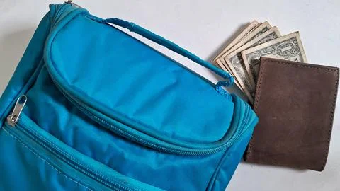 Close-up of a blue backpack with cash and wallet inside. Casual travel Stock Photos