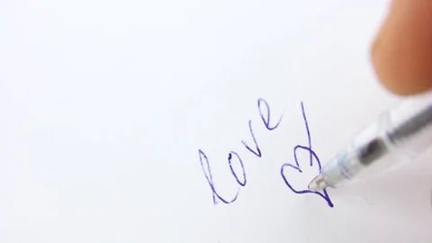 Close-up blue ballpoint pen writes love and draw heart shape, copy space Video stock 126998771