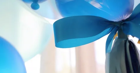 Close-up blue bow ribbon on balloon floating decorate celebration party Stock Footage 85113952