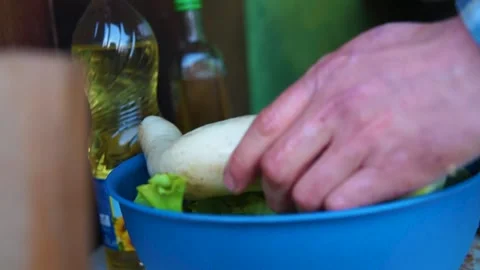 A close-up of a blue bowl, inside it there are washed lettuce leaves. 動画素材 160992553