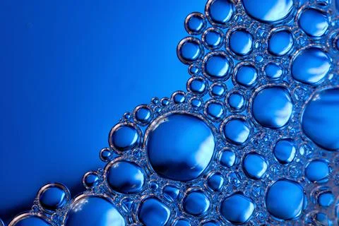 Close-up of blue bubbles on a blue background. Stock Photos