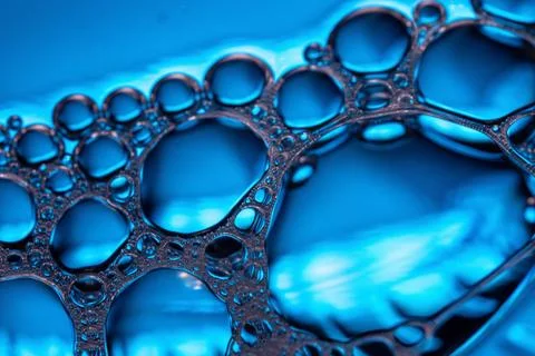 Close-up of blue bubbles forming a network pattern. 스톡 사진