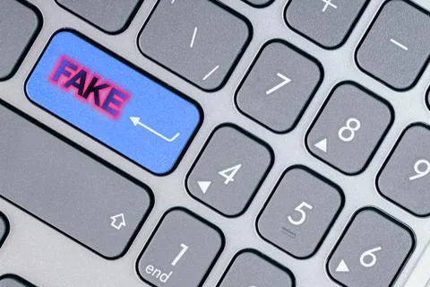 Close-up of a blue button with fake text on a conceptual keyboard. Concept of Stock Photos