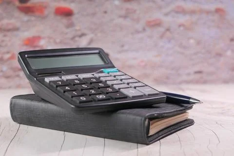 Close up of blue calculator and notepad on color background 写真素材