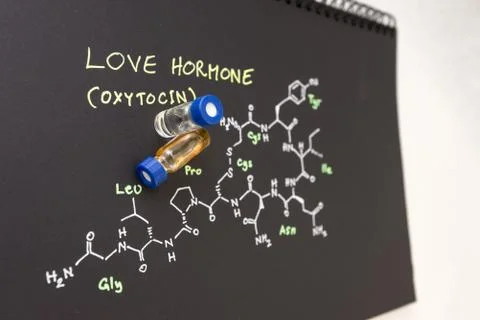 Close-up blue cap sample vial on notebook with chemical formula of Oxytocin Stock Photos
