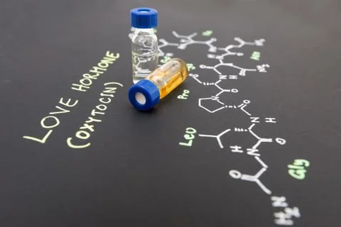 Close-up blue cap sample vial on paper with chemical formula of Oxytocin (l.. Stock Photos