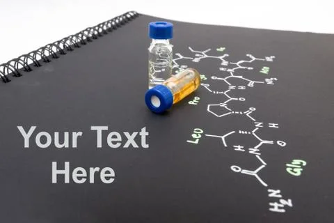 Close-up blue cap sample vial on notebook with chemical formula of Oxytocin.. Stock Photos