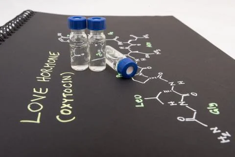 Close-up blue cap sample vial on paper with chemical formula of Oxytocin Stock Photos