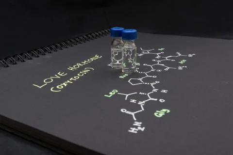 Close-up blue cap sample vial on paper with chemical formula of Oxytocin Stock Photos