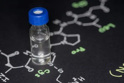 Close-up blue cap sample vial on paper with chemical formula of Oxytocin (l.. Stock Photos